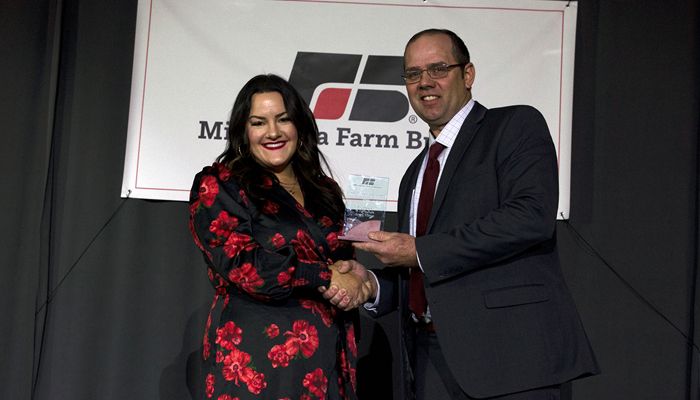 Kristy Miron and President Dan Glessing with award