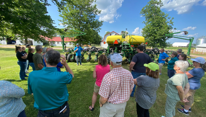 Group of people standing by a tractor