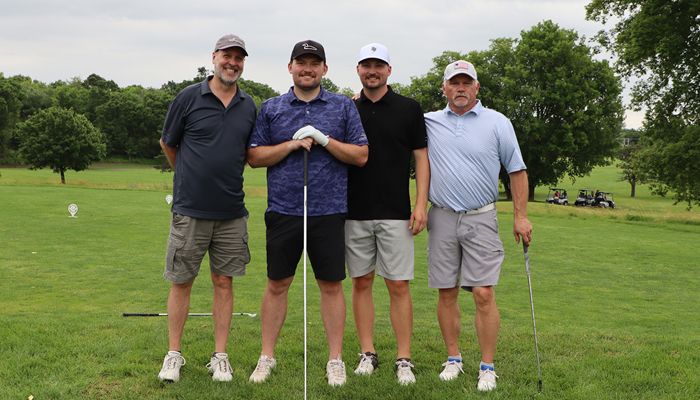 four golfers posed for group photo