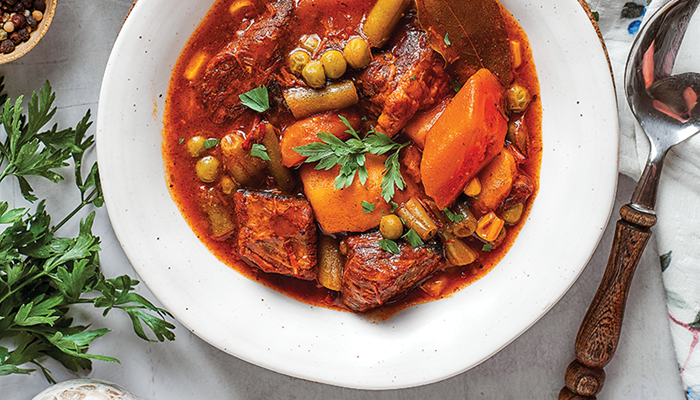 overhead photo of mulligan stew in white bowl