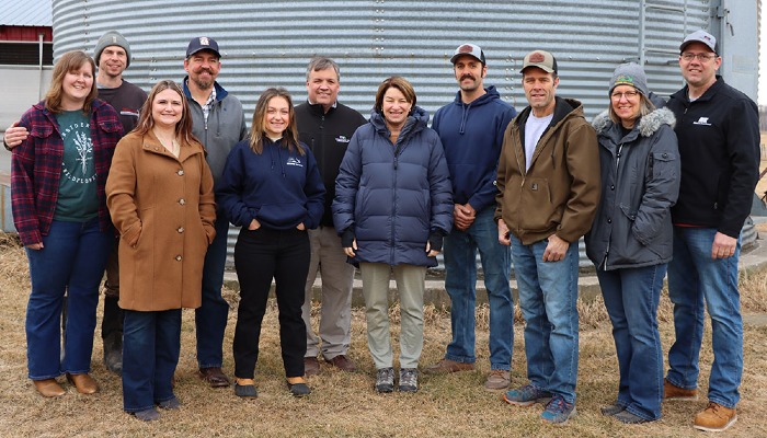 group of people on a farm tour posed for a photo