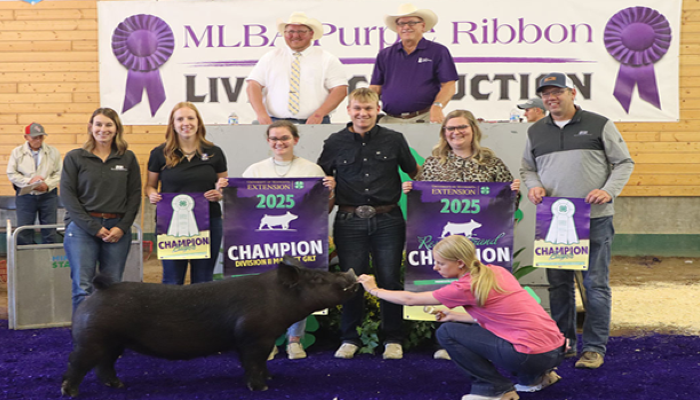 MFBF staff and the Thome family smile for a photo together at the Purple Ribbon Auction