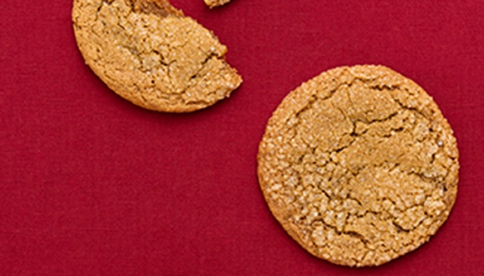 overhead photo of ginger cookies on red tablecloth