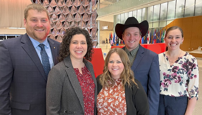 group of two men and three women standing together for a photo