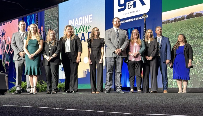 people standing on a stage waiting for an announcement