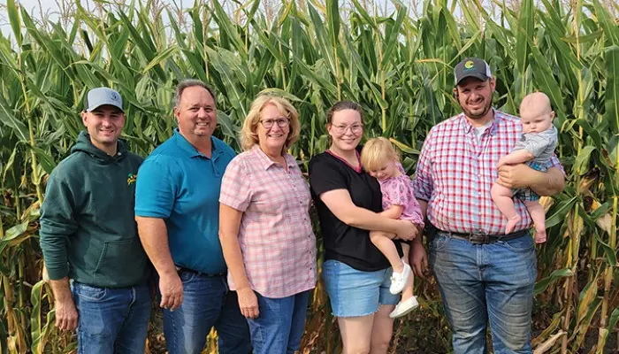 seven family members standing in front of corn