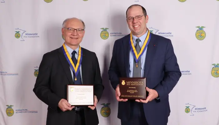 President Dan Glessing and Membership and Marketing Specialist Dennis Sabel stand with their awards