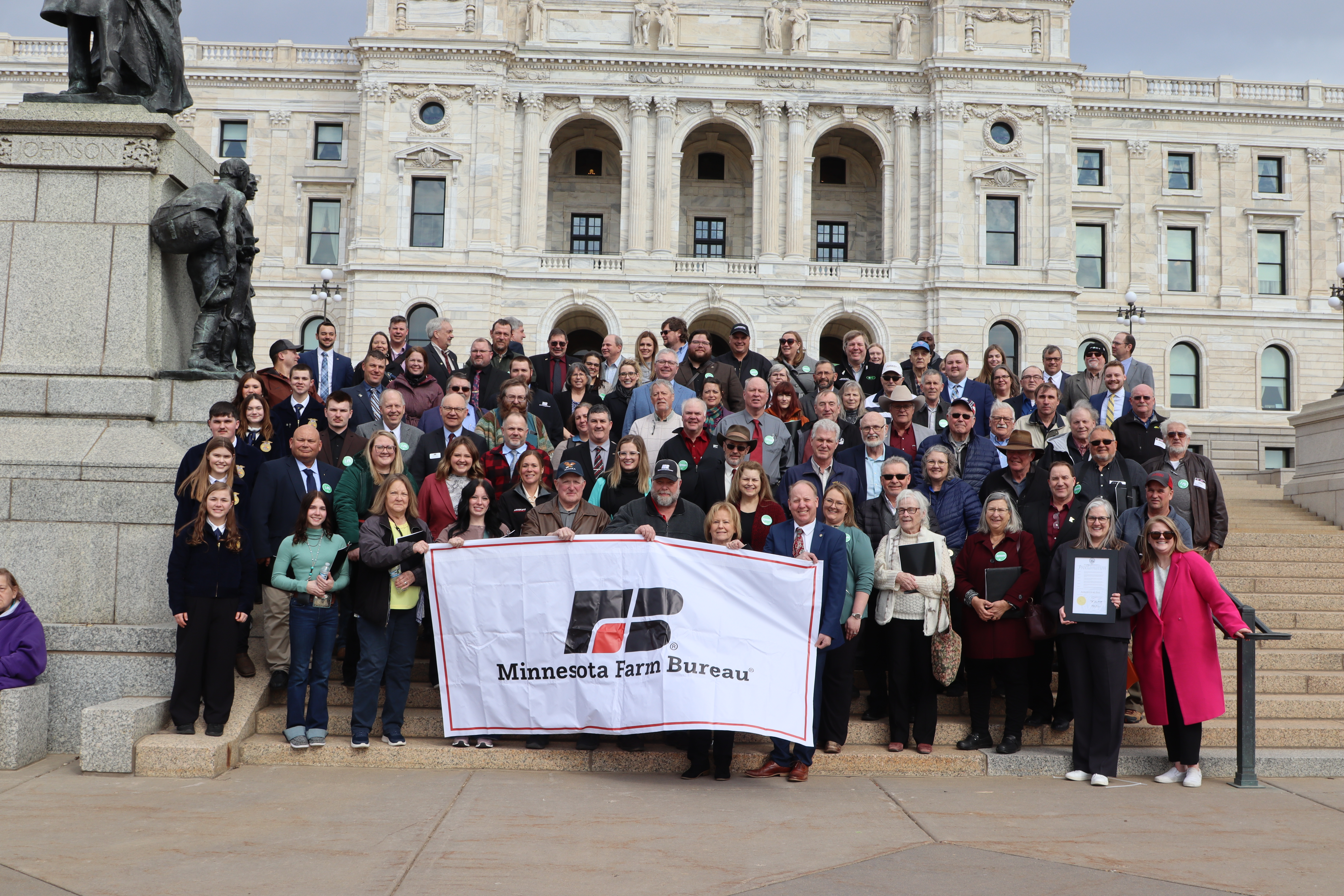 group of people standing on the steps of the Minnesota capitol